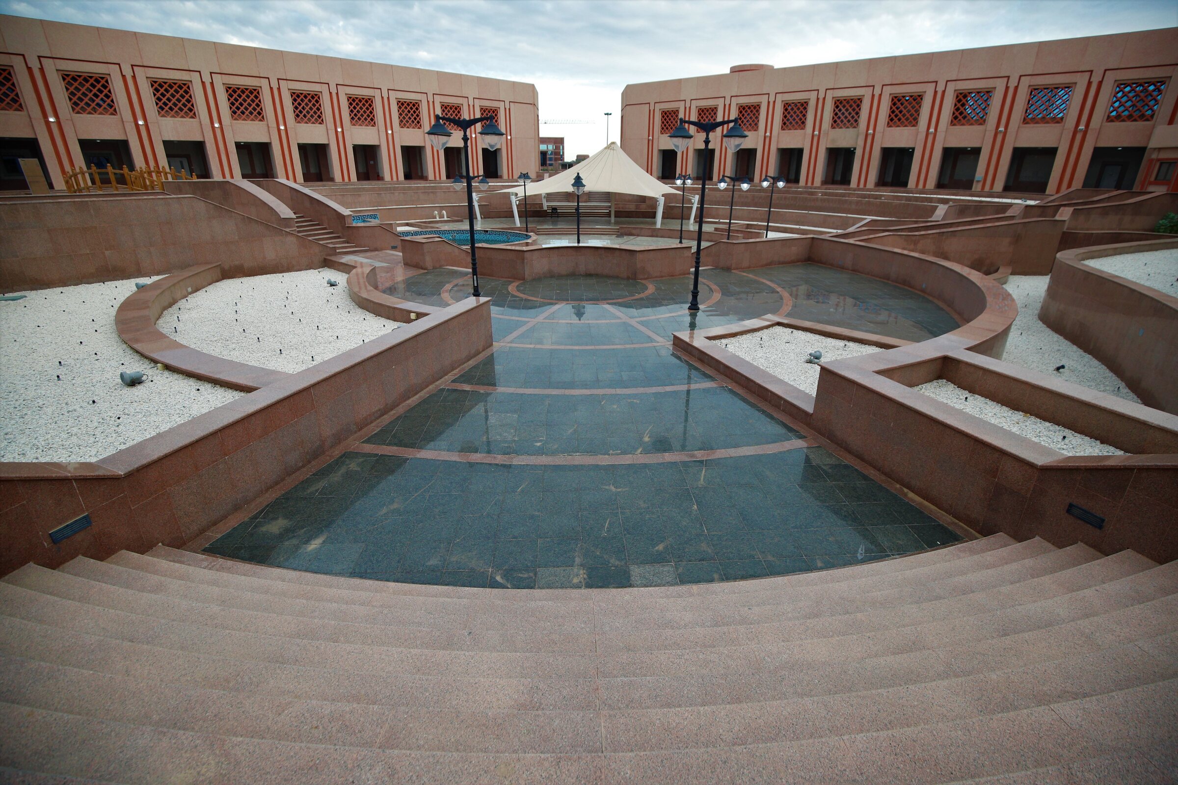 Central Taibah University courtyard with terraced paths and water features